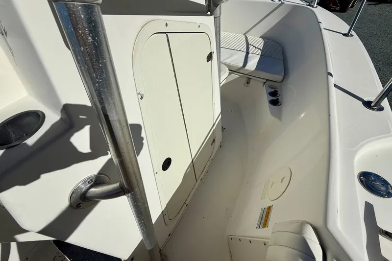 Slide: The Image of 2001 Boston Whaler 230 Outrage boat interior with seating and storage compartment. - 30