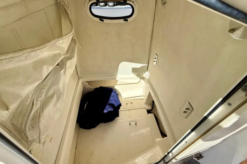 Slide: The Image of Interior cabin of 2001 Boston Whaler 230 Outrage boat with storage compartments. - 31