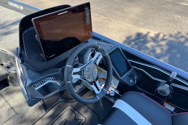 Slide: The Image of Interior of 2026 Skeee FXR 21 Flex boat with advanced steering and navigation systems. - 12