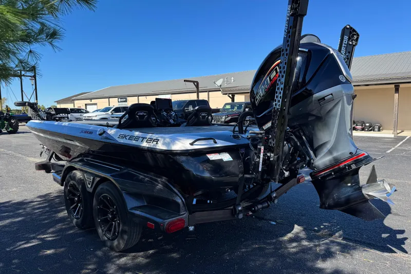 Slide: The Image of 2026 Skeeter FXR 21 Flex boat with powerful outboard motor in parking lot. - 3
