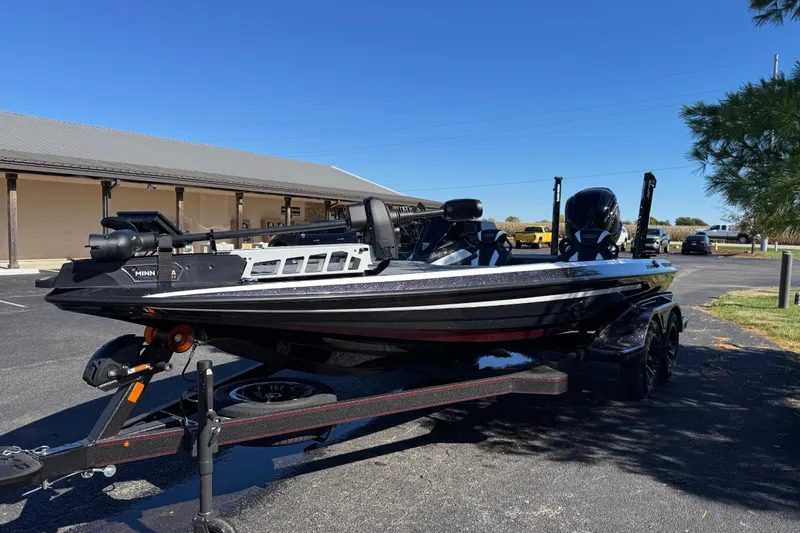 Slide: The Image of 2026 Skeee FXR 21 Flex boat on trailer in parking lot, sunny day. - 5