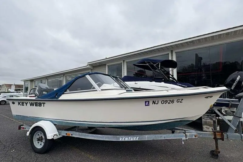 The Image of 2006 Key West 1720 Dual Console boat on trailer, parked outside dealership. - 1
