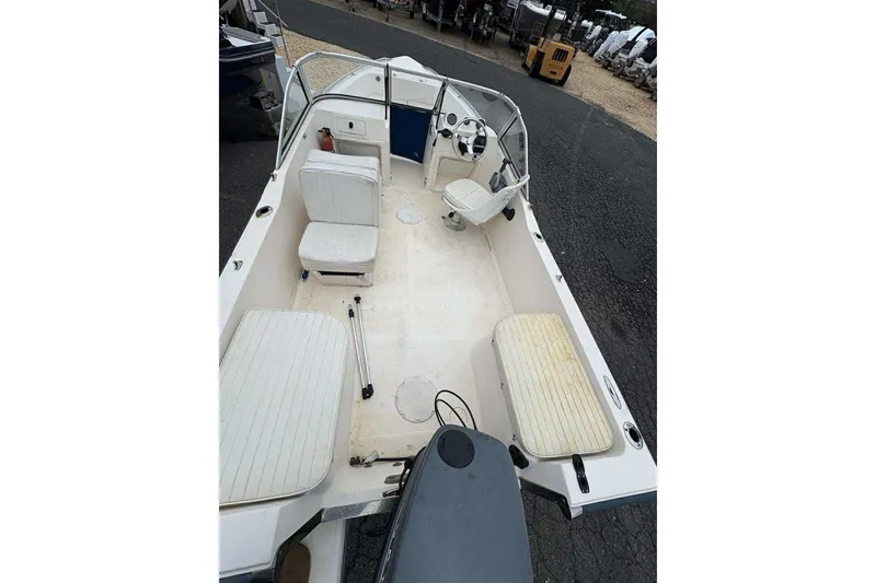 Slide: The Image of 2006 Key West 1720 Dual Console boat interior with seating and steering wheel. - 12