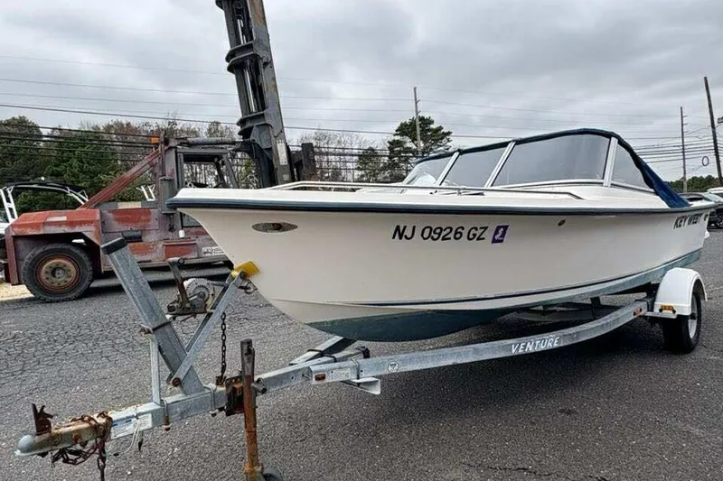 Slide: The Image of 2006 Key West 1720 Dual Console boat on trailer, parked outdoors. - 2