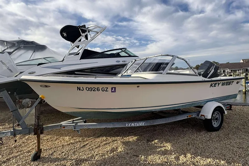 Slide: The Image of 2006 Key West 1720 Dual Console boat on trailer, parked outdoors. - 4