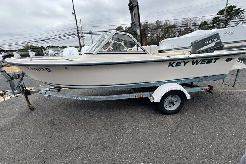 Slide: The Image of 2006 Key West 1720 Dual Console boat on trailer, parked outdoors. - 5
