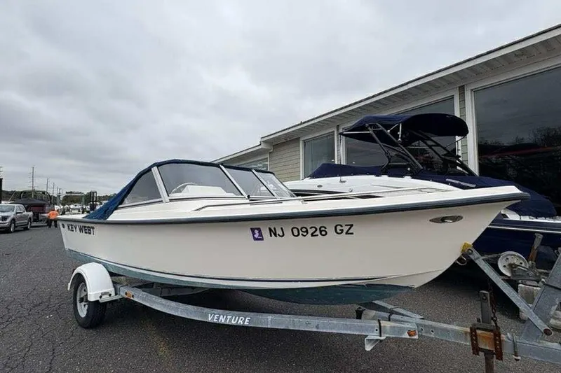 Slide: The Image of 2006 Key West 1720 Dual Console boat on trailer, parked outdoors. - 6