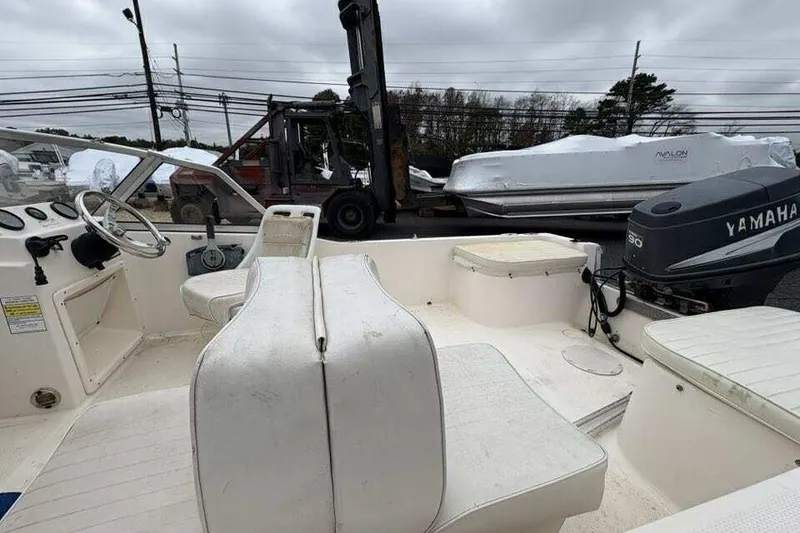 Slide: The Image of 2006 Key West 1720 Dual Console boat interior with Yamaha engine, parked outdoors. - 9