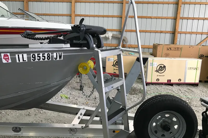 Slide: The Image of 2004 Crestliner Canadian 18 Tiller boat on trailer in storage facility. - 11