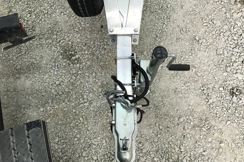 Slide: The Image of Trailer hitch of a 2004 Crestliner Canadian 18 Tiller on gravel surface. - 12