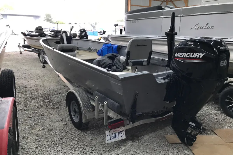 Slide: The Image of 2004 Crestliner Canadian 18 Tiller boat with Mercury 60 outboard motor on trailer. - 3