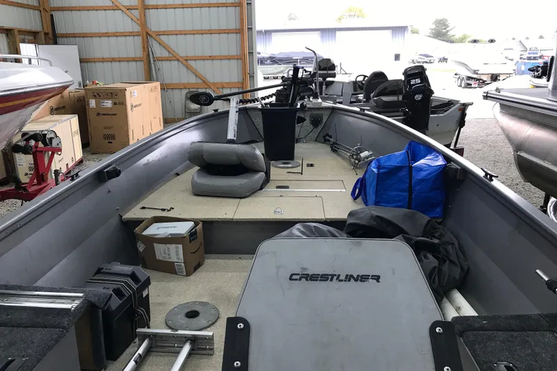 Slide: The Image of 2004 Crestliner Canadian 18 Tiller boat interior in storage, featuring seating and equipment. - 7