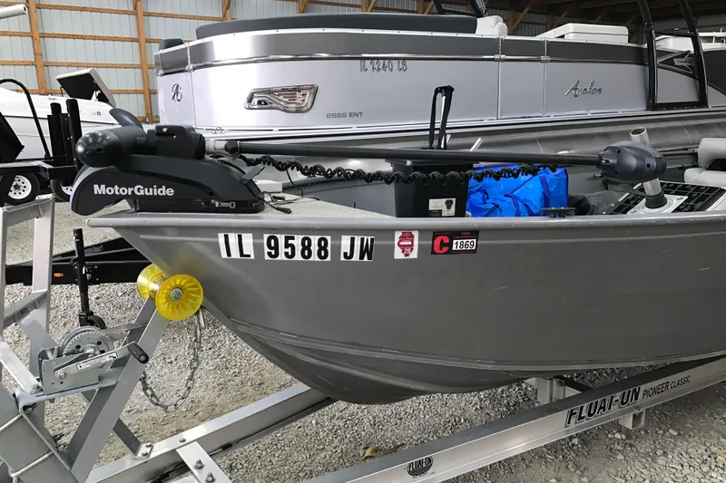 Slide: The Image of 2004 Crestliner Canadian 18 Tiller boat on trailer, featuring MotorGuide trolling motor. - 9