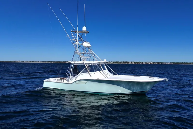 The Image of 2006 Out Island 38 Express boat on open water under clear blue sky. - 0