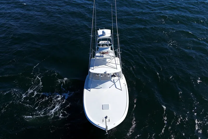 Slide: The Image of 2006 Out Island 38 Express boat cruising on open water, aerial view. - 10