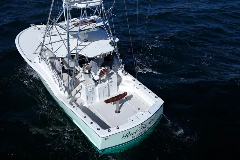 Slide: The Image of 2006 Out Island 38 Express boat cruising on open water, aerial view. - 13