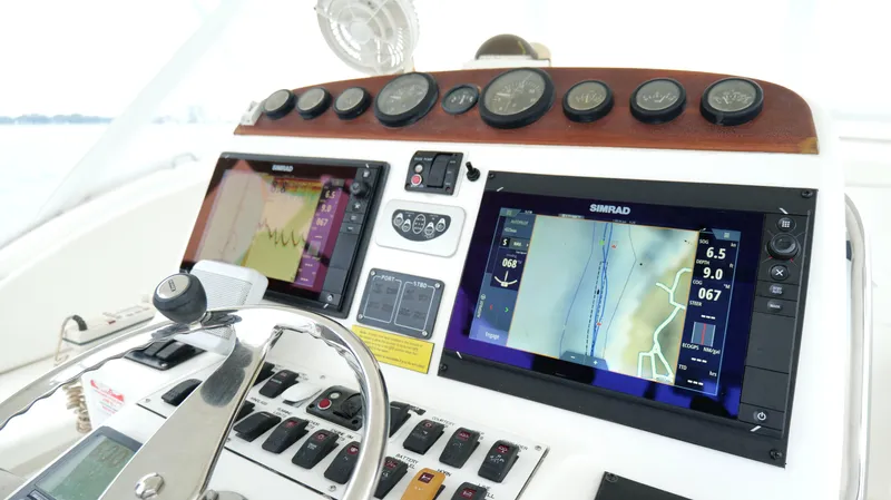Slide: The Image of Control panel of a 2006 Out Island 38 Express boat with navigation screens and gauges. - 15