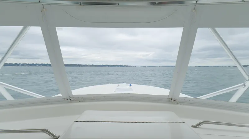 Slide: The Image of 2006 Out Island 38 Express boat view from helm, overlooking calm waters. - 20