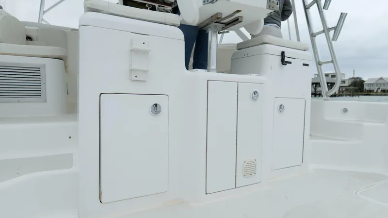 Slide: The Image of 2006 Out Island 38 Express boat deck with storage compartments and seating. - 31