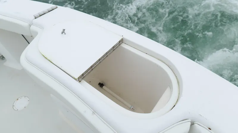 Slide: The Image of Open storage compartment on 2006 Out Island 38 Express boat, near ocean water. - 35