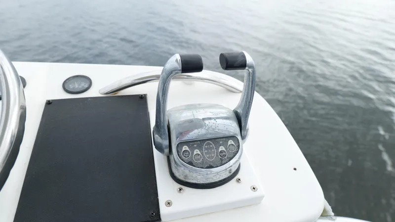 Slide: The Image of Throttle controls on 2006 Out Island 38 Express boat, overlooking calm water. - 44