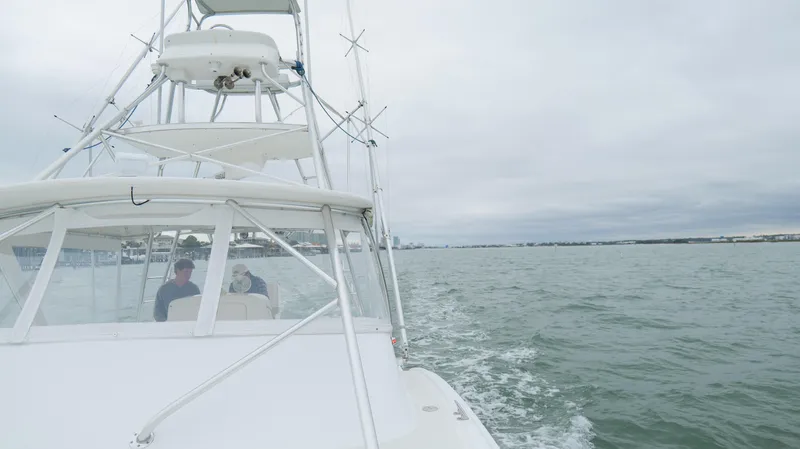 Slide: The Image of 2006 Out Island 38 Express boat cruising on open water under cloudy skies. - 47
