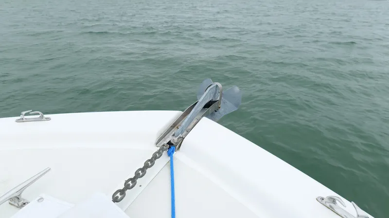 Slide: The Image of Bow of 2006 Out Island 38 Express with anchor chain over water. - 49