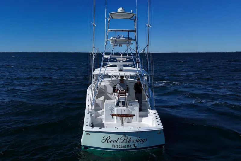 Slide: The Image of 2006 Out Island 38 Express boat on open sea, clear blue sky. - 7