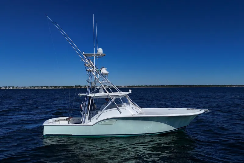 Slide: The Image of 2006 Out Island 38 Express boat on calm blue ocean under clear sky. - 9
