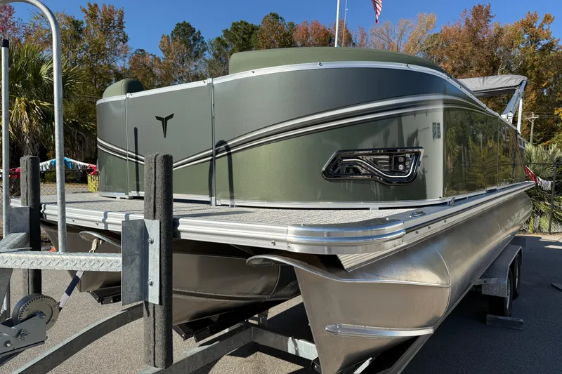 Slide: The Image of 2026 Tahoe Pontoon LTZ Quad Lounger on trailer, showcasing sleek design and modern features. - 2