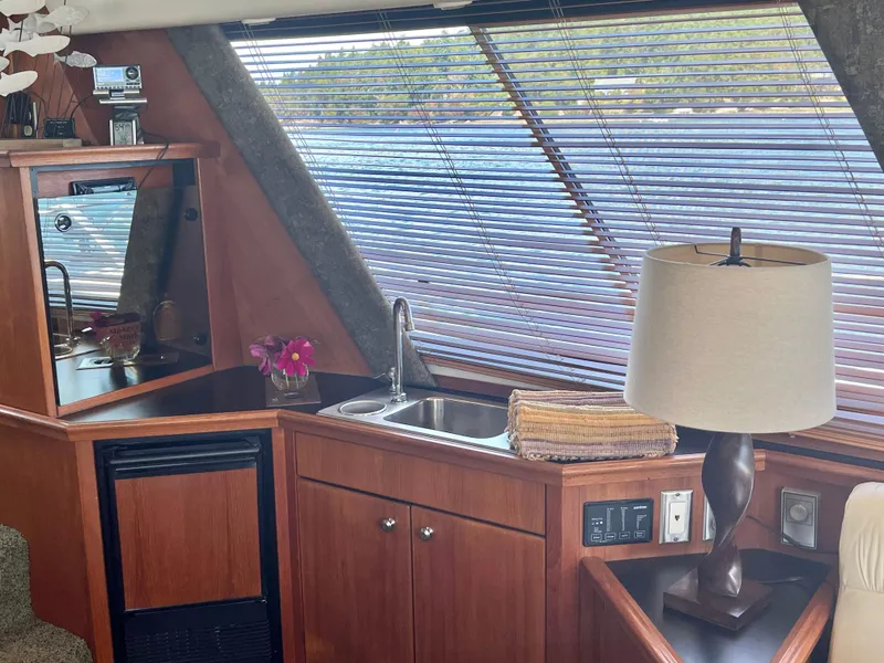 Slide: The Image of Interior of 1994 Bayliner 4788 Pilot House Motoryacht with sink, lamp, and window blinds. - 11