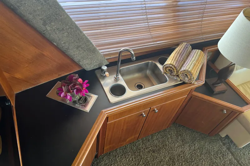 Slide: The Image of Luxurious 1994 Bayliner 4788 yacht interior with sink, flowers, and rolled towels. - 12
