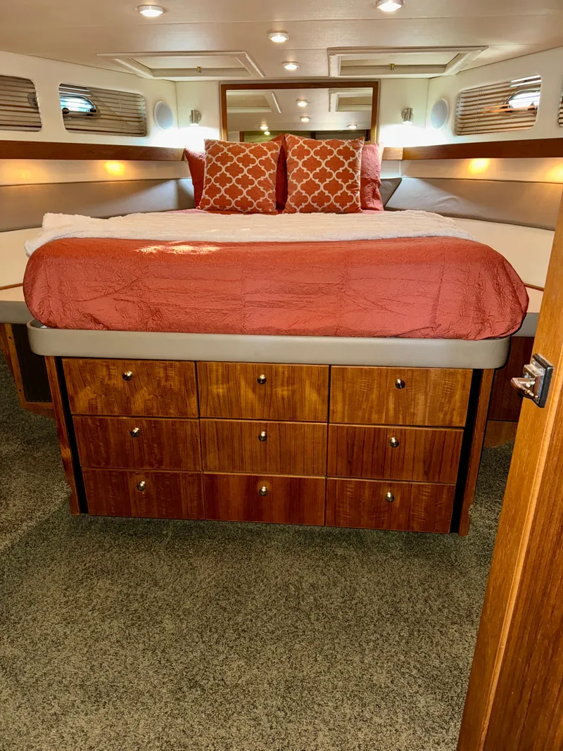 Slide: The Image of Luxurious bedroom in 1994 Bayliner 4788 Pilot House Motoryacht with elegant bedding and ample storage. - 15