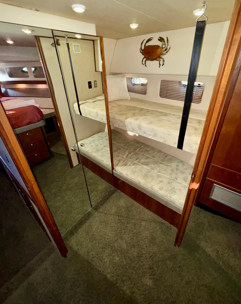 Slide: The Image of Interior of 1994 Bayliner 4788 Pilot House Motoryacht with bunk beds and nautical decor. - 19