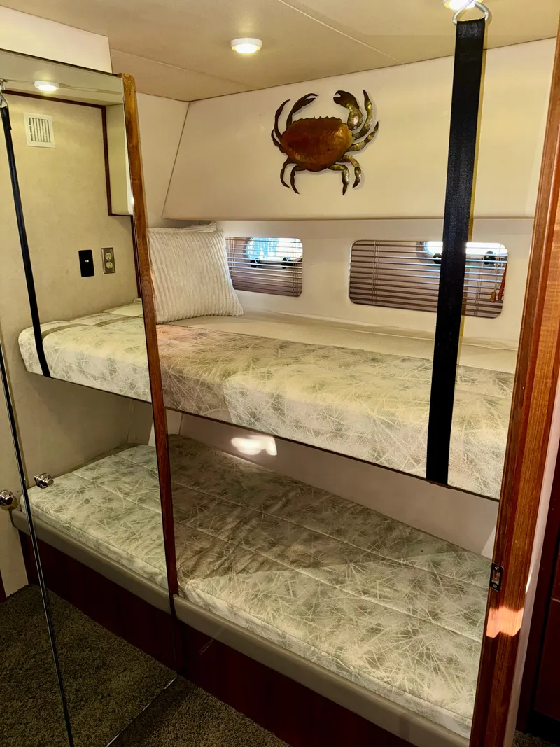 Slide: The Image of 1994 Bayliner 4788 Pilot House Motoryacht cabin with bunk beds and nautical decor. - 20