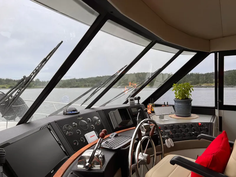 Slide: The Image of 1994 Bayliner 4788 Pilot House Motoryacht interior with steering wheel and panoramic windows. - 3