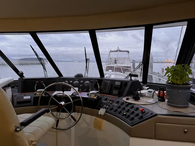 Slide: The Image of 1994 Bayliner 4788 Pilot House Motoryacht interior with steering wheel and control panel. - 4