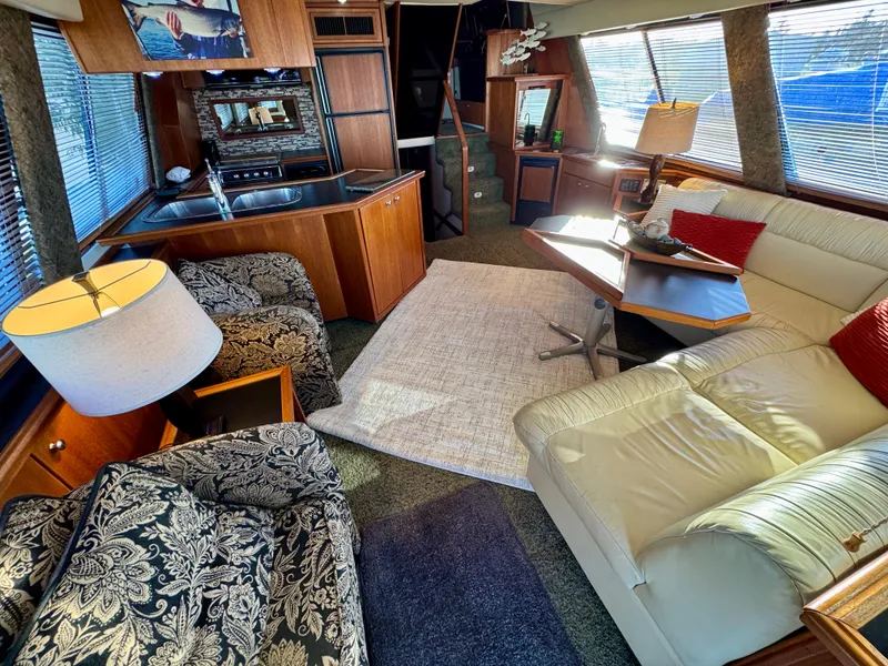 Slide: The Image of Luxurious interior of a 1994 Bayliner 4788 Pilot House Motoryacht with elegant furnishings. - 6