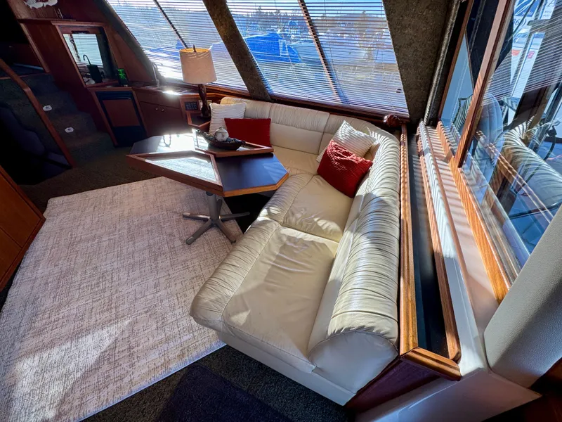 Slide: The Image of Luxurious interior of 1994 Bayliner 4788 Pilot House Motoryacht with plush seating and elegant decor. - 9