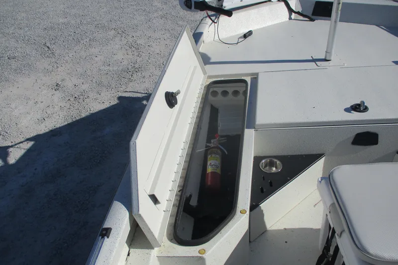 Slide: The Image of 2018 Ranger RB190 Bay boat storage compartment with fire extinguisher and cup holder. - 12