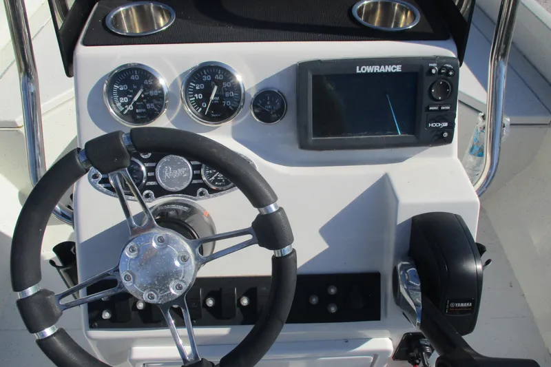Slide: The Image of 2018 Ranger RB190 Bay boat dashboard with steering wheel, gauges, and Lowrance display. - 8