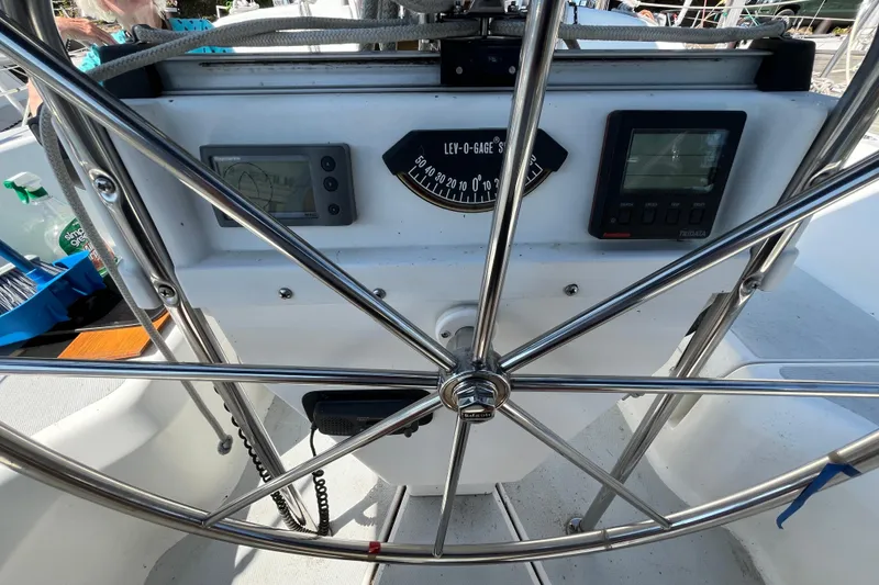 Slide: The Image of Steering wheel and instruments on a 1994 Hunter 29.5 sailboat cockpit. - 16