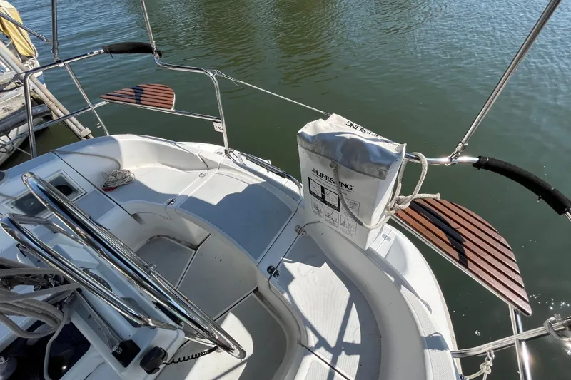 Slide: The Image of Cockpit of a 1994 Hunter 29.5 sailboat with lifebuoy and wooden seats. - 17