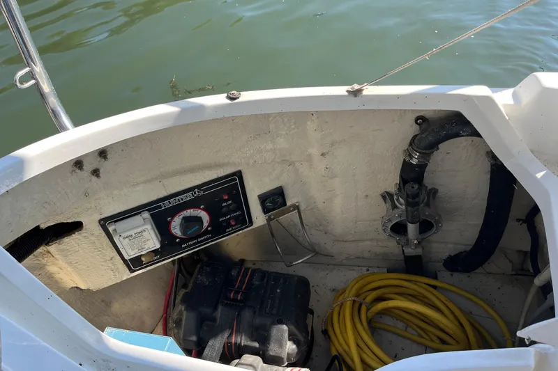 Slide: The Image of 1994 Hunter 29.5 boat cockpit with battery switch, wiring, and yellow hose. - 19
