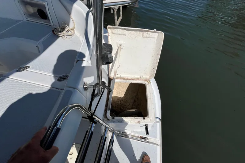 Slide: The Image of Open hatch on 1994 Hunter 29.5 sailboat, docked by water. - 21