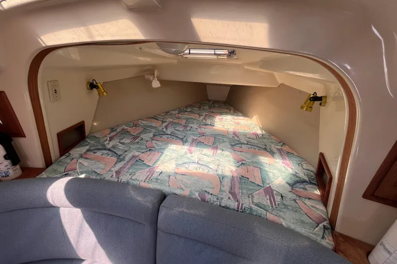 Slide: The Image of Cozy cabin interior of 1994 Hunter 29.5 sailboat with patterned bedding. - 24