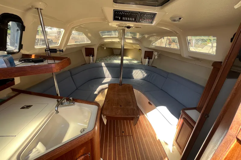 Slide: The Image of Interior of 1994 Hunter 29.5 sailboat with cozy seating and wooden finishes. - 25