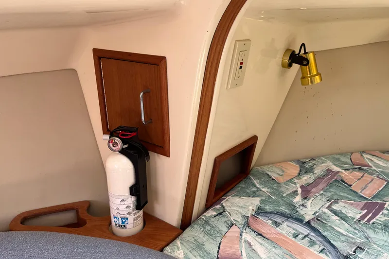 Slide: The Image of Interior of 1994 Hunter 29.5 sailboat with fire extinguisher and reading light. - 27