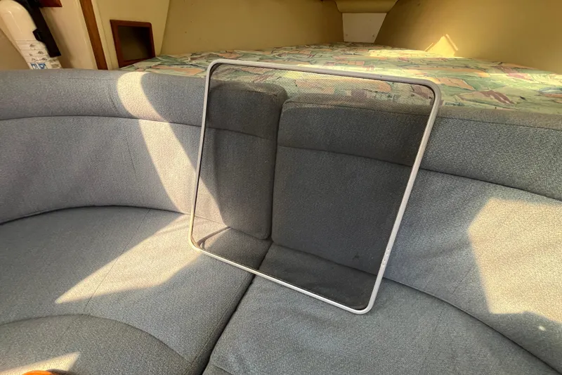 Slide: The Image of Interior of 1994 Hunter 29.5 sailboat with gray seating and window frame. - 28