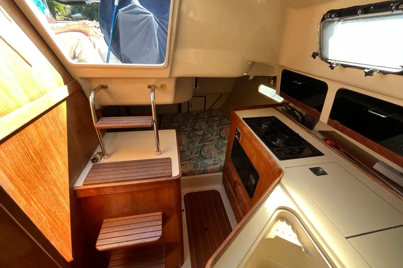 Slide: The Image of Interior of a 1994 Hunter 29.5 sailboat with compact kitchen and cozy sleeping area. - 34